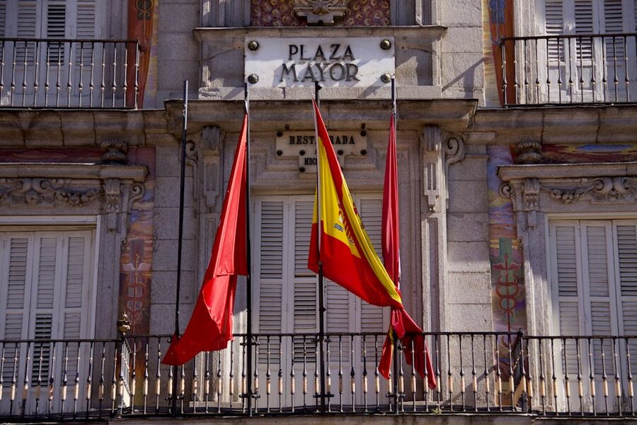 Plaza Mayor Madrid Casa de la Panaderia facade detail with Spanish flags