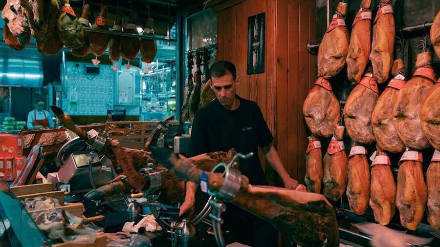 Man slicing jamon in Barcelona market shop