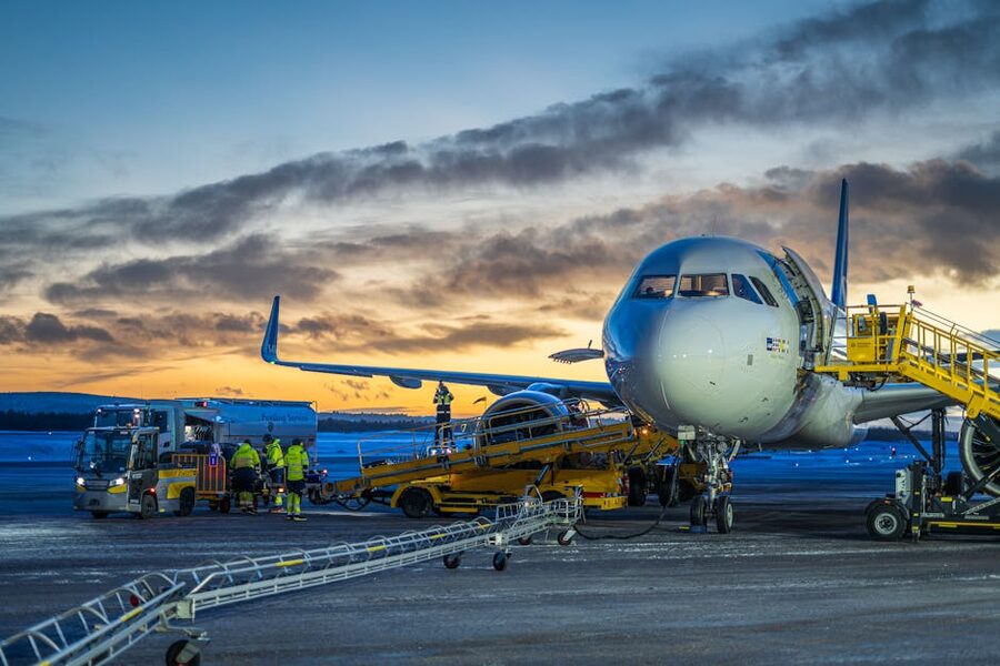 Aircraft de-icing at Kiruna Airport during winter sunrise
