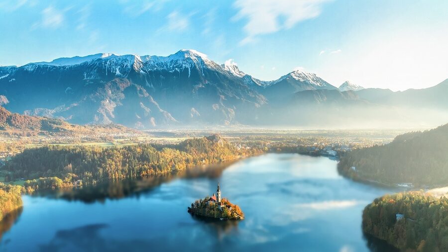 Lake Bled covered in morning mist with Bled Island just visible