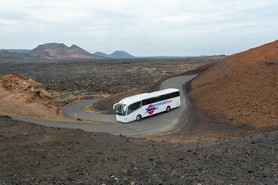 Tour coach driving through Lanzarote volcanic terrain