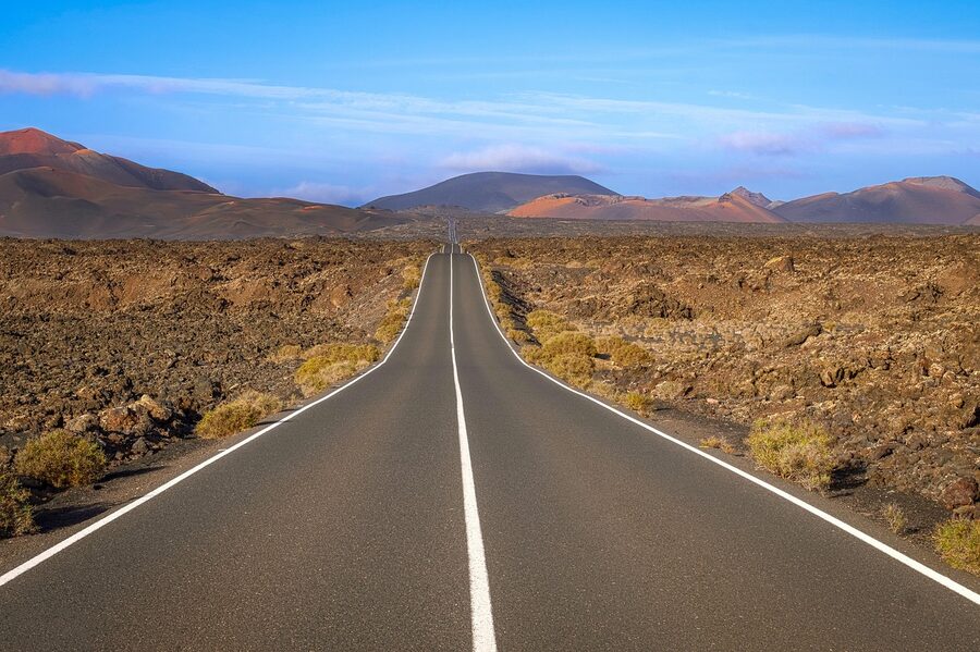 Tourists looking out over Lanzarote volcanic landscape
