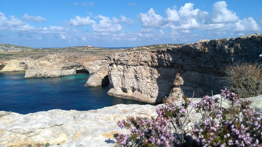 Limestone cliffs on Malta's coast above clear lagoon water