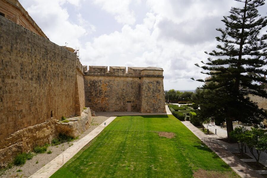 Mdina fortress walls under blue Maltese sky, central Malta