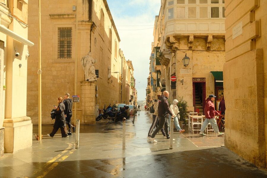 Pedestrians walking through historic Mdina streets, central Malta