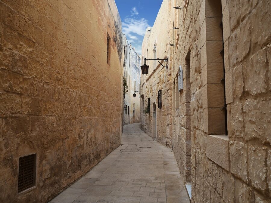 Narrow stone alley with arched passage in Mdina, Malta