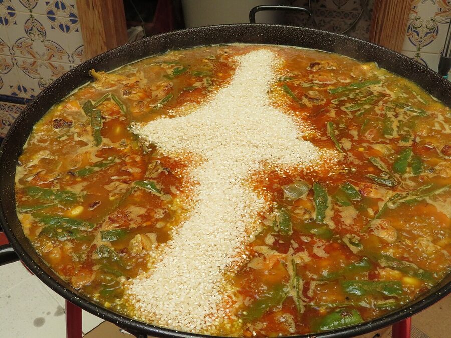 Pouring rice into the paella pan