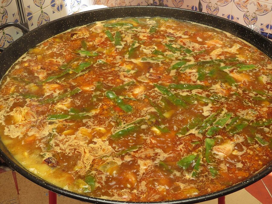 Paella stock starting to boil in the pan