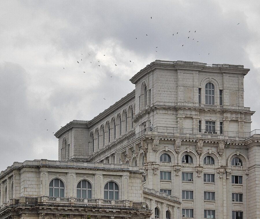 Palace of Parliament Bucharest under dark stormy clouds
