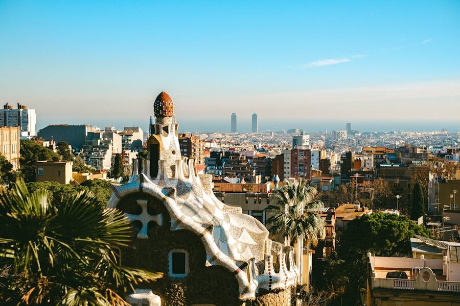Aerial view of Park Guell mosaic terrace and Barcelona cityscape