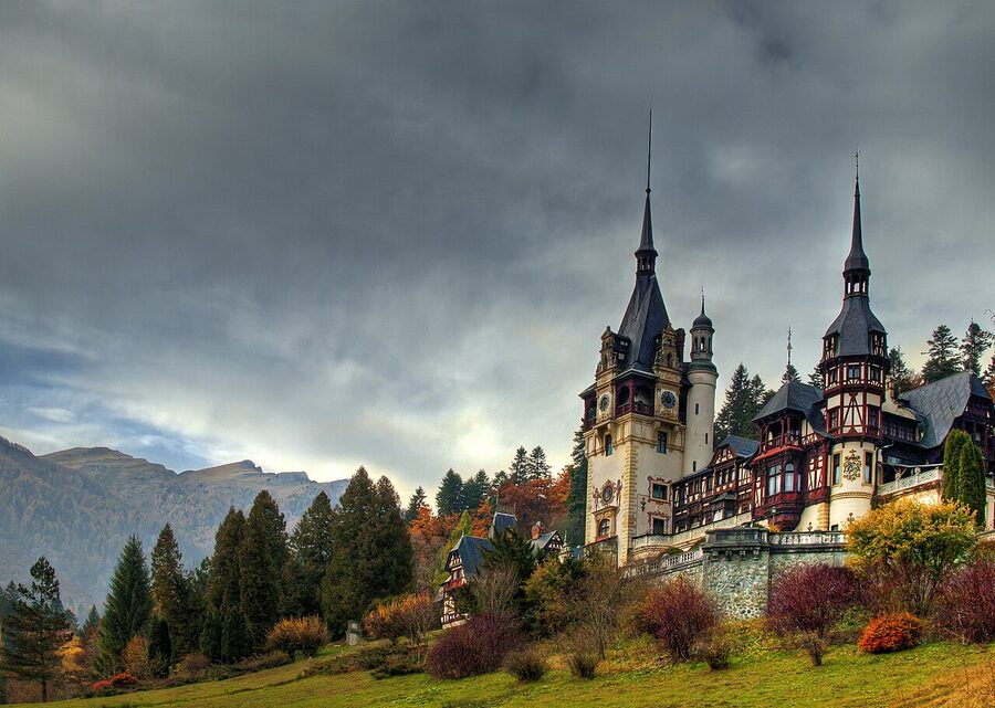 Panoramic view of Peles Castle with Carpathian peaks behind
