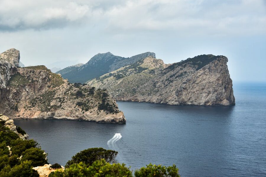Mallorca cliffs with a passing speedboat