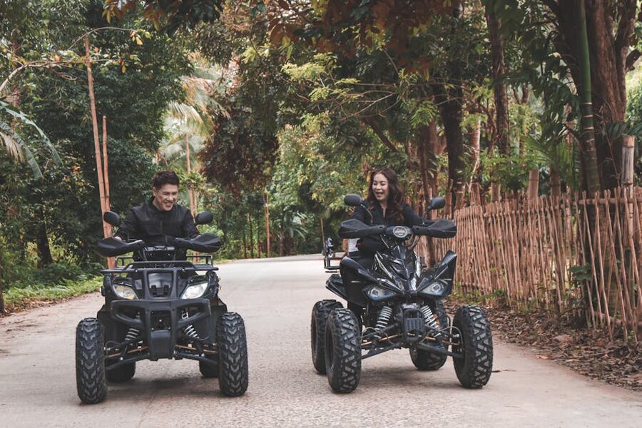 Couple riding quad bikes through Mallorca-style countryside