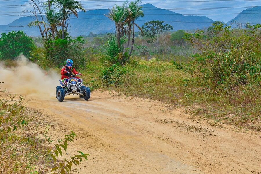 Quad bike on a rural forest trail in green countryside