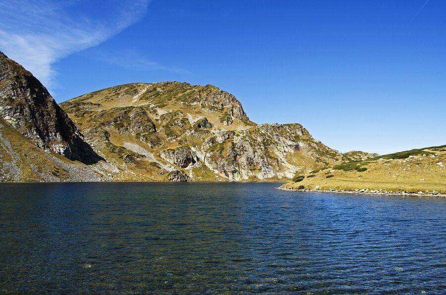 Bulgarian alpine lake under blue sky in the Rila range