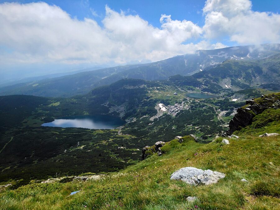 Rila Lakes in summer, clear water and snow patches still on the peaks