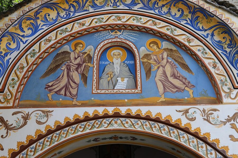 Rila Monastery courtyard with painted arches and Bulgarian frescoes
