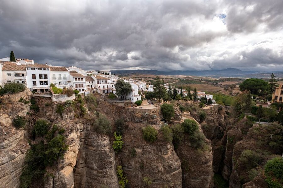 Ronda cliffside buildings against dramatic skies
