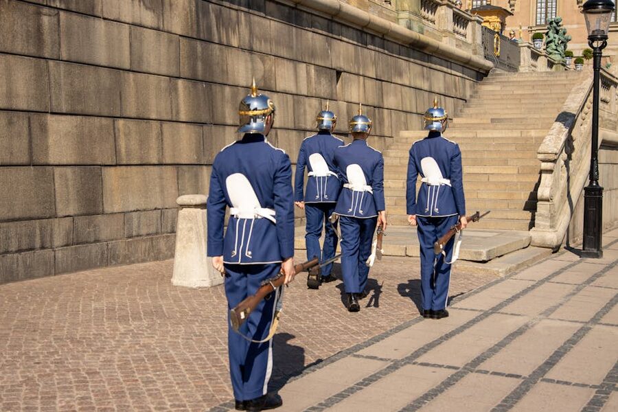 Swedish Royal Guards marching at Stockholm Palace on sunny day