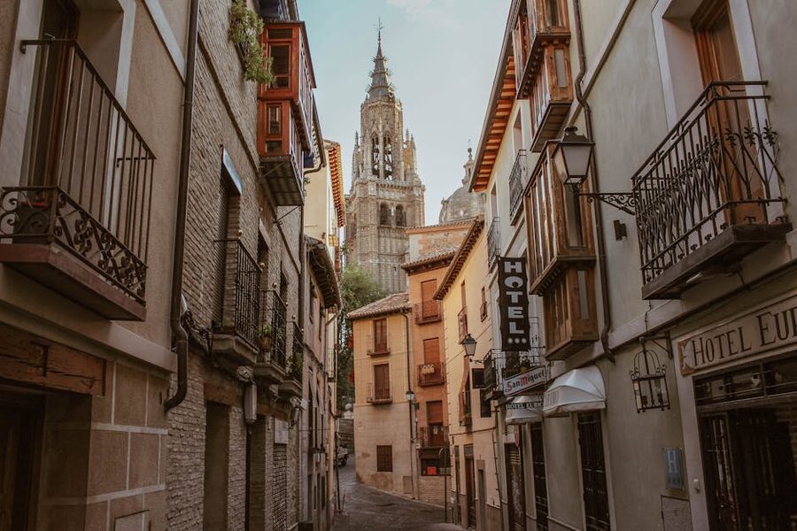 Narrow Toledo street with cathedral spire visible