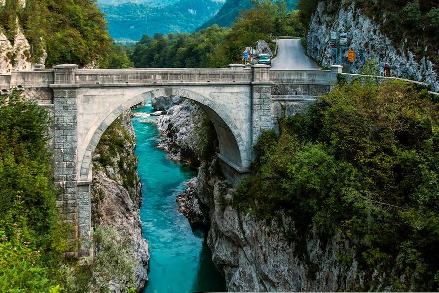 Stone arch bridge over the turquoise Soca River