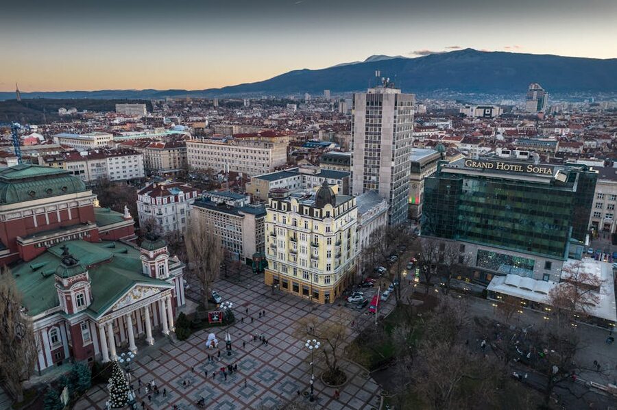 Aerial view of Sofia at sunset showing the city skyline and Vitosha Mountain