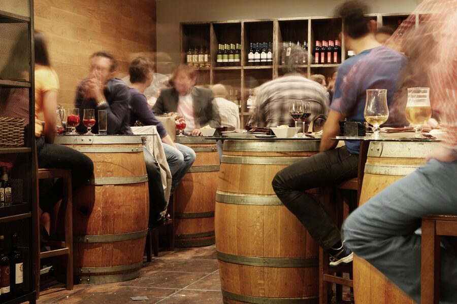 Spanish tapas bar with rustic wine barrels and patrons