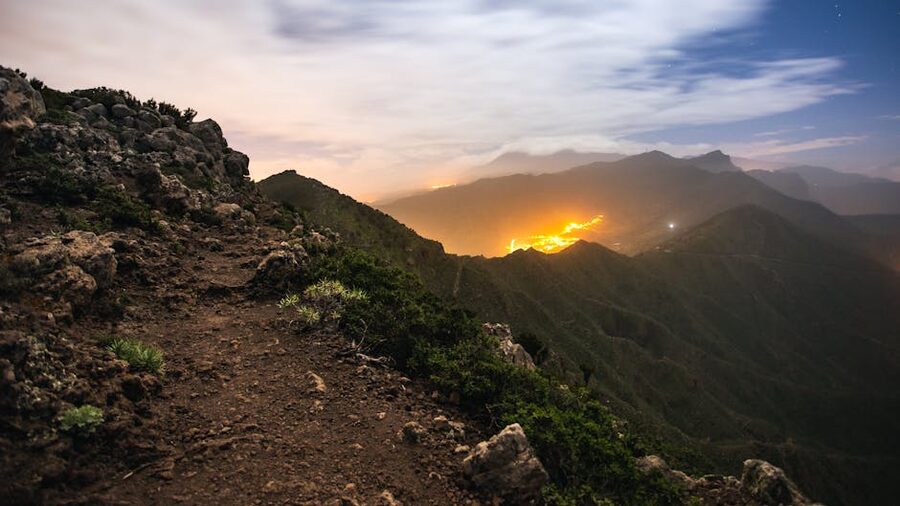 Tenerife mountains under a starry sky with city lights from the resorts below