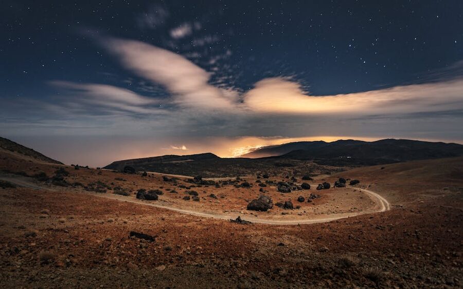 Rocky field in Teide National Park under an evening sky with the first stars visible