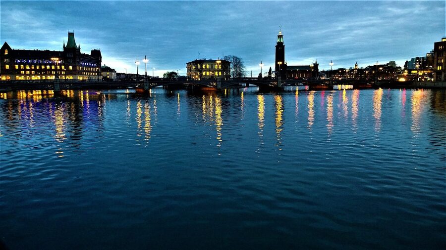 Stockholm City Hall mirrored on still water at dawn