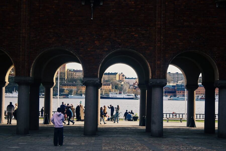 Stockholm waterfront in spring framed by an archway near City Hall