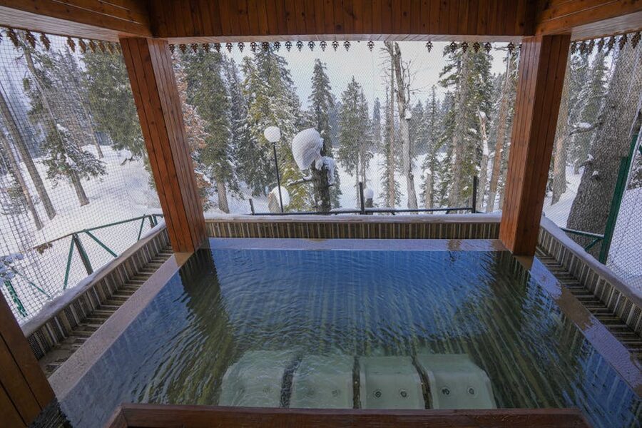 Winter thermal pool with snow on the trees