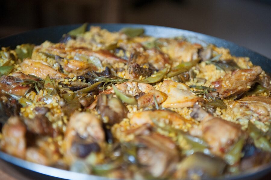 Traditional Valencian paella with rabbit, chicken, and artichokes