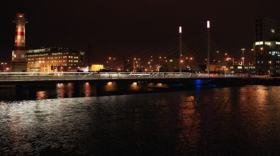 Malmö canal at night with city lights reflecting on water