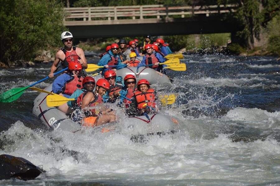 Rafters with paddles splashing on a fast river