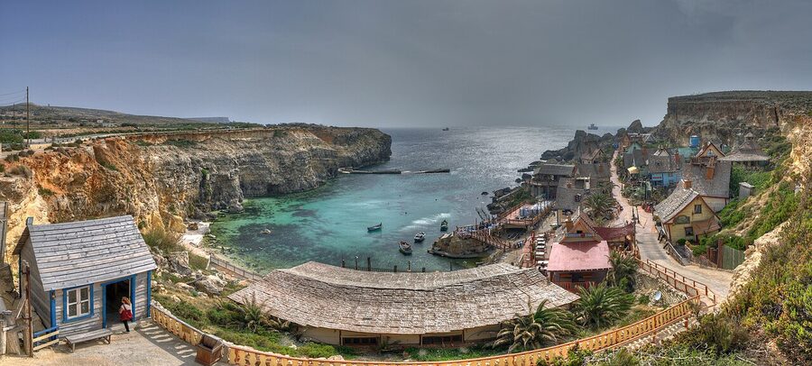 Popeye Village Anchor Bay Mellieha cliffs and wooden buildings