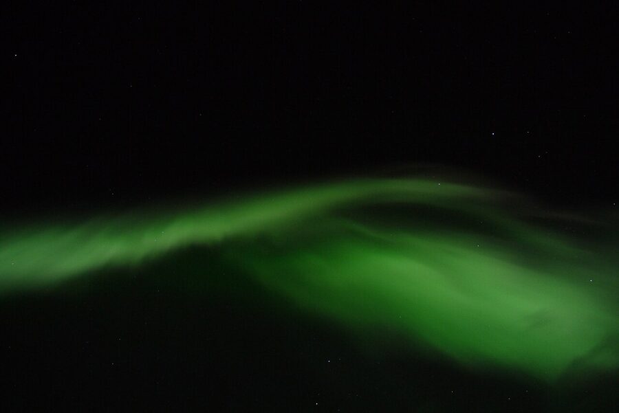 Aurora arc spanning the night sky over Kiruna
