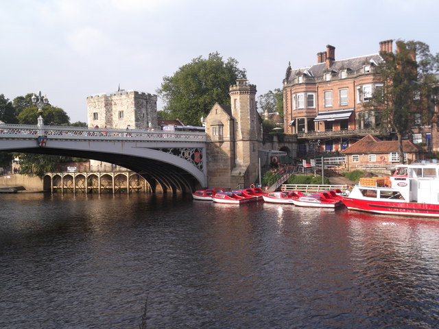 Sightseeing boats moored at Lendal Bridge landing on the River Ouse in York