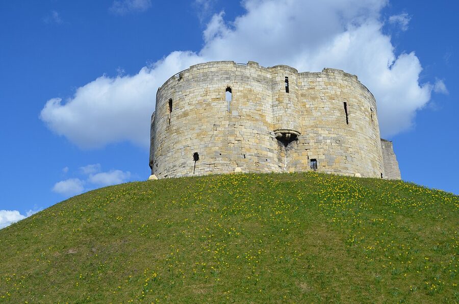 Clifford's Tower in York with daffodils on the slope