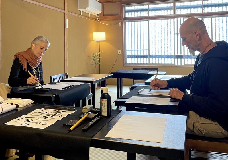 Hands-on Zen Calligraphy & 150-Year-Old Kyoto Machiya Tour - Grinding ink before the first stroke