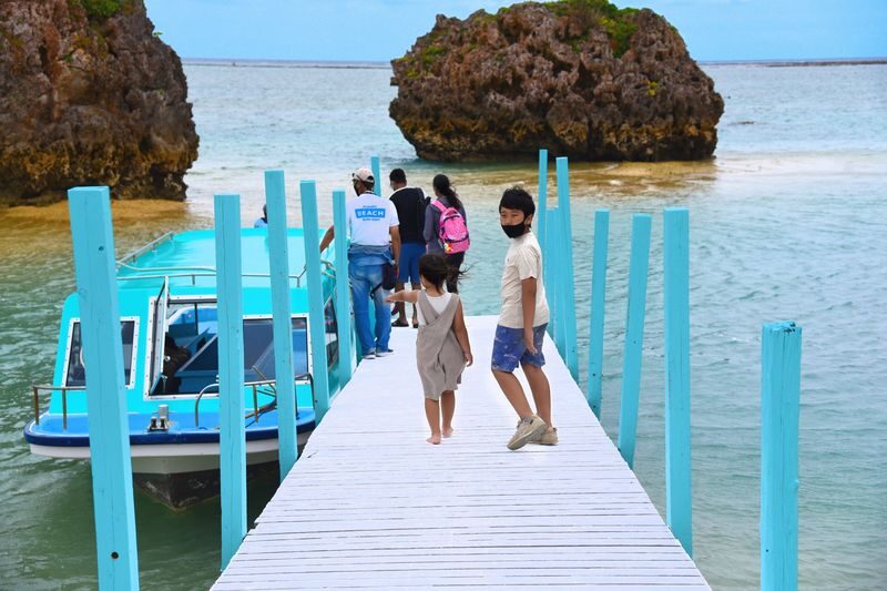 Okinawa: Miibaru Beach Glass Bottom Boat Tour Experience - Mibaru Beach is part of the outing