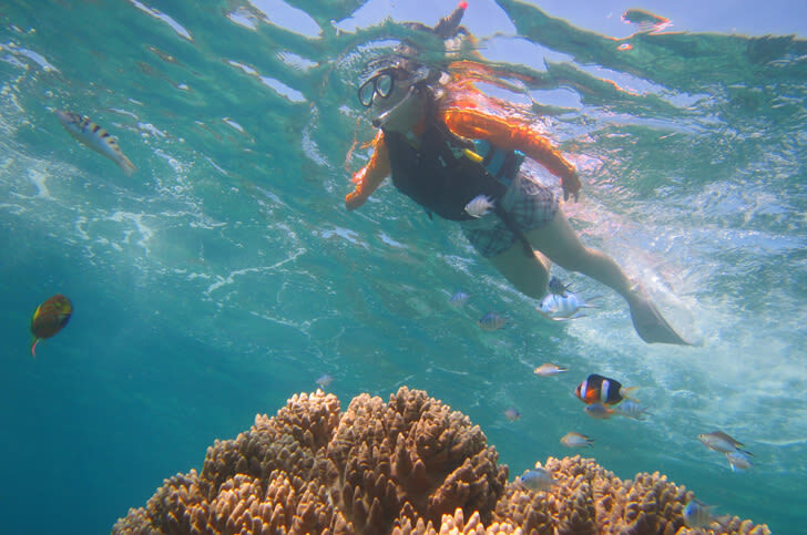 Onna Village Banana Boat & Snorkelling Experience in Okinawa - A gentle ride with a view toward Cape Manza